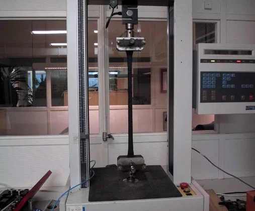 Aquastrip bitumen joint sealing strip being tested for elongation